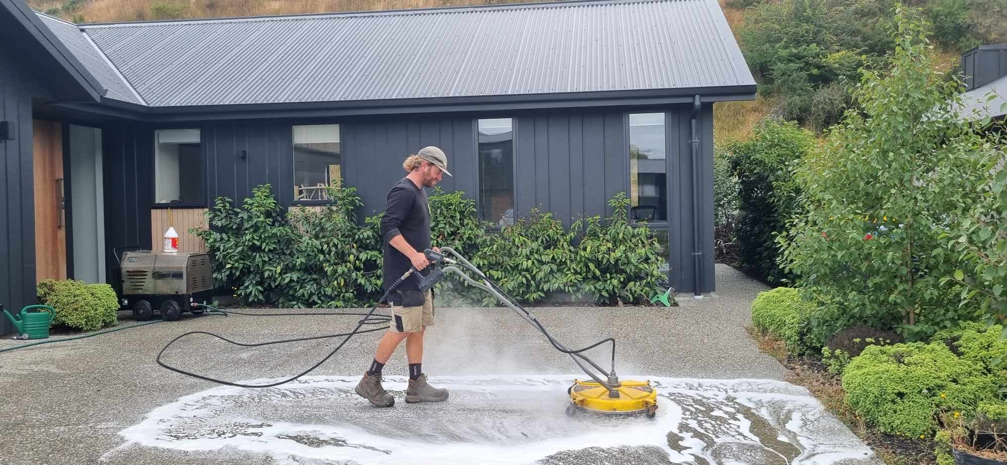 RTS consctruction chemicals team steam cleaning a driveway in Queenstown