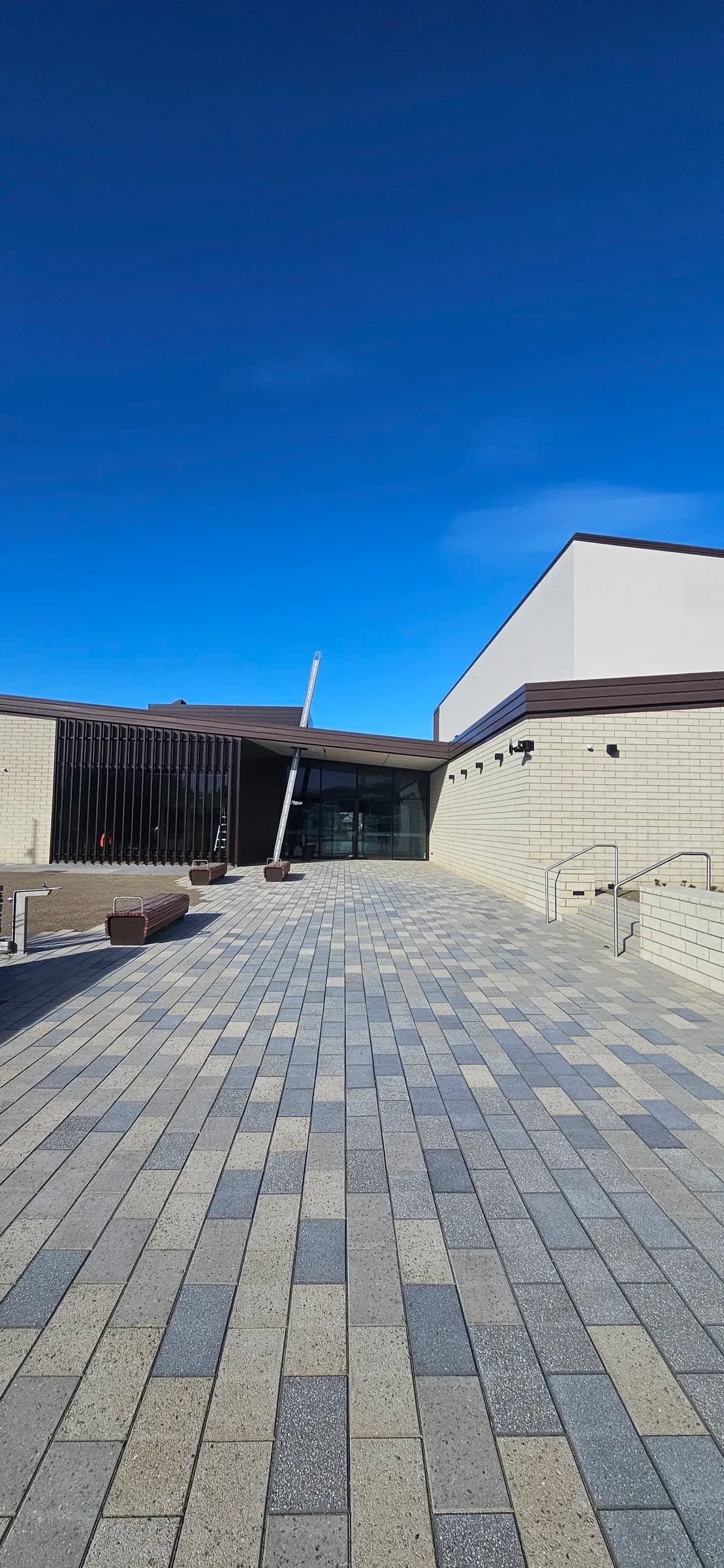 Paved entry plaza and acid-washed viblock brick walls at Cromwell Memorial Hall