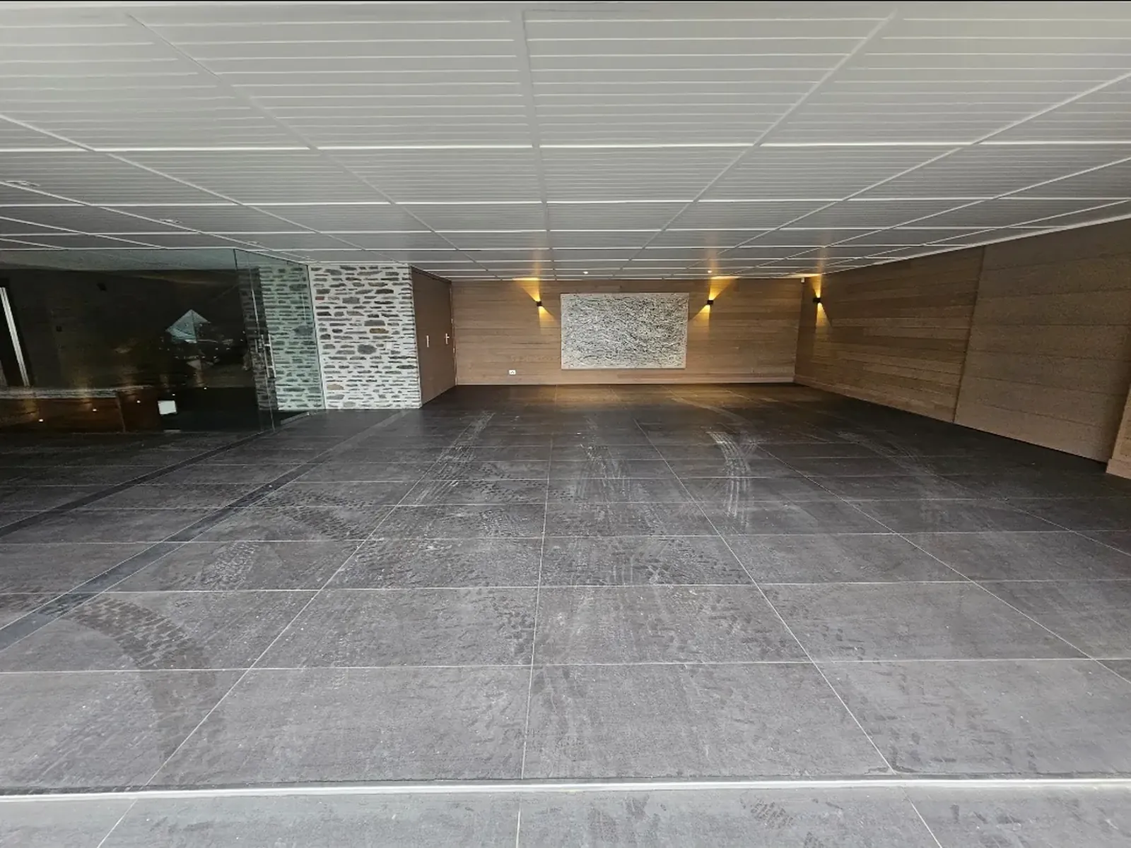 Interior ceramic tile floor with footprints and construction marks before cleaning, Wanaka