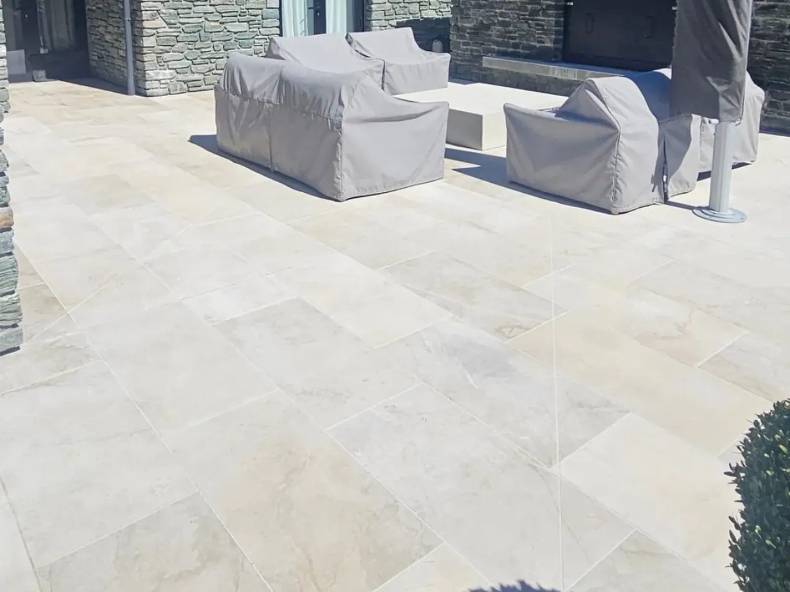 Same limestone patio cleaned and dried, schist gable and outdoor furniture in place, Wanaka